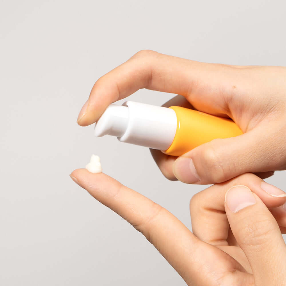 Applying BARULAB Vitamin C Niacinamide Whitening Eye Serum 30ml on fingertip