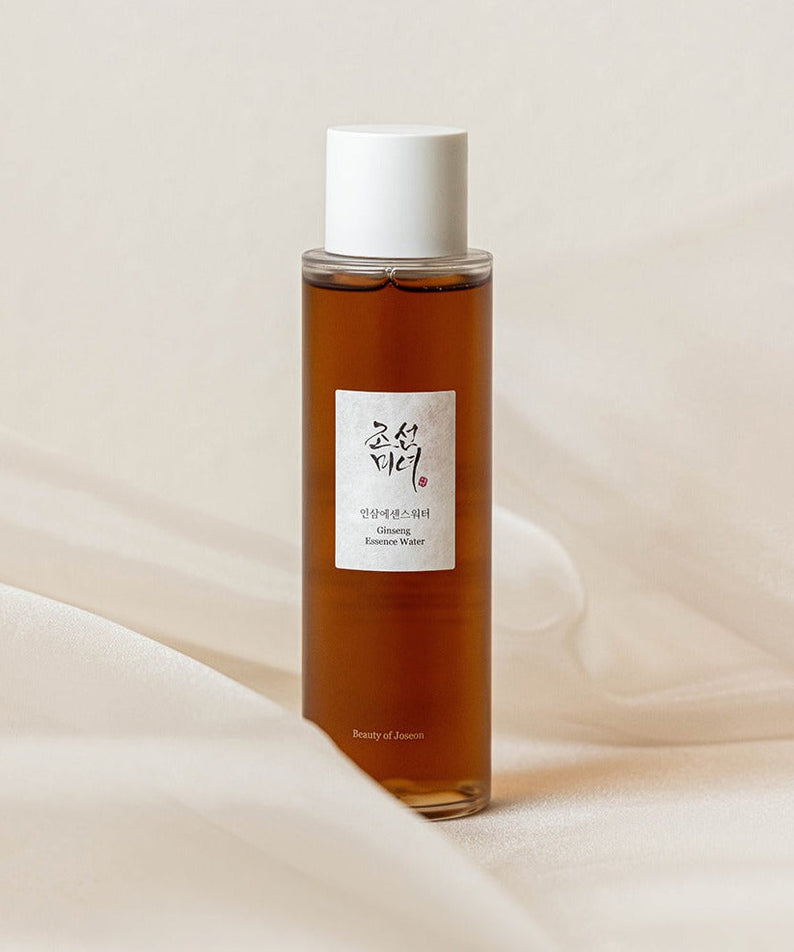 Image of BEAUTY OF JOSEON Ginseng Essence Water 150ml bottle on a soft fabric background.