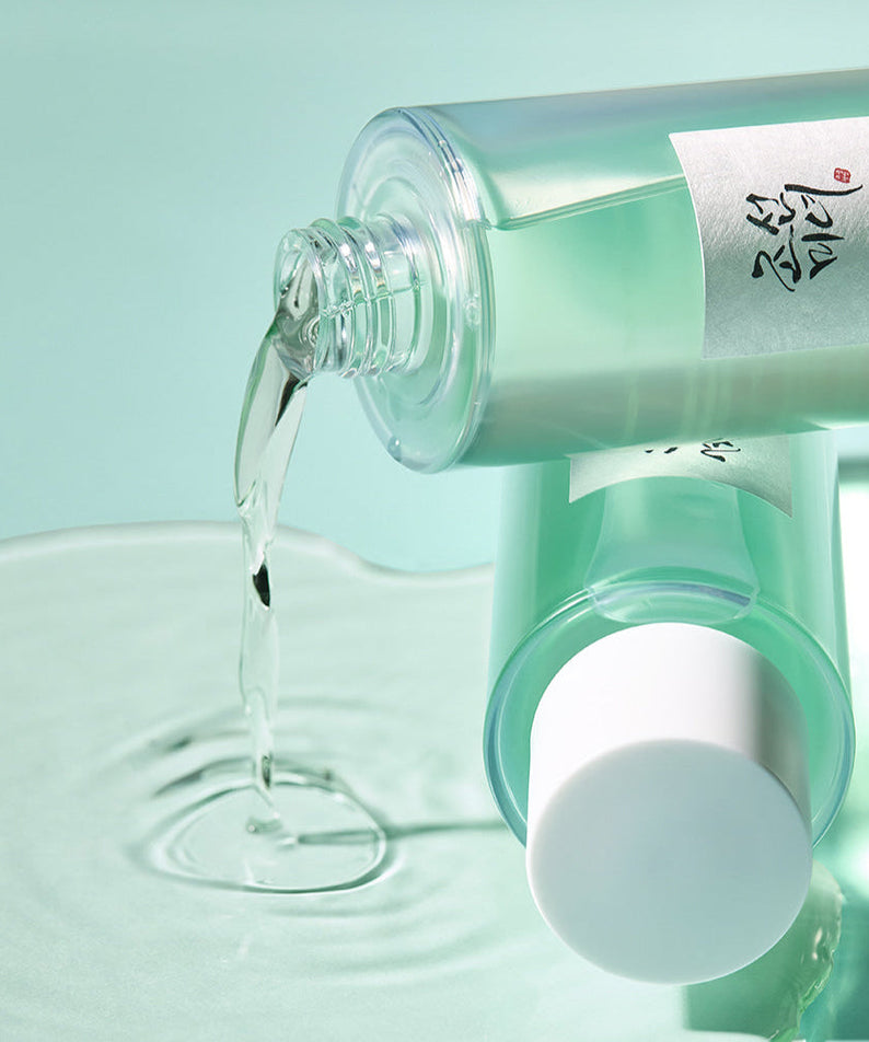 BEAUTY OF JOSEON Green Plum Refreshing Toner AHA + BHA 150ml bottle pouring on surface