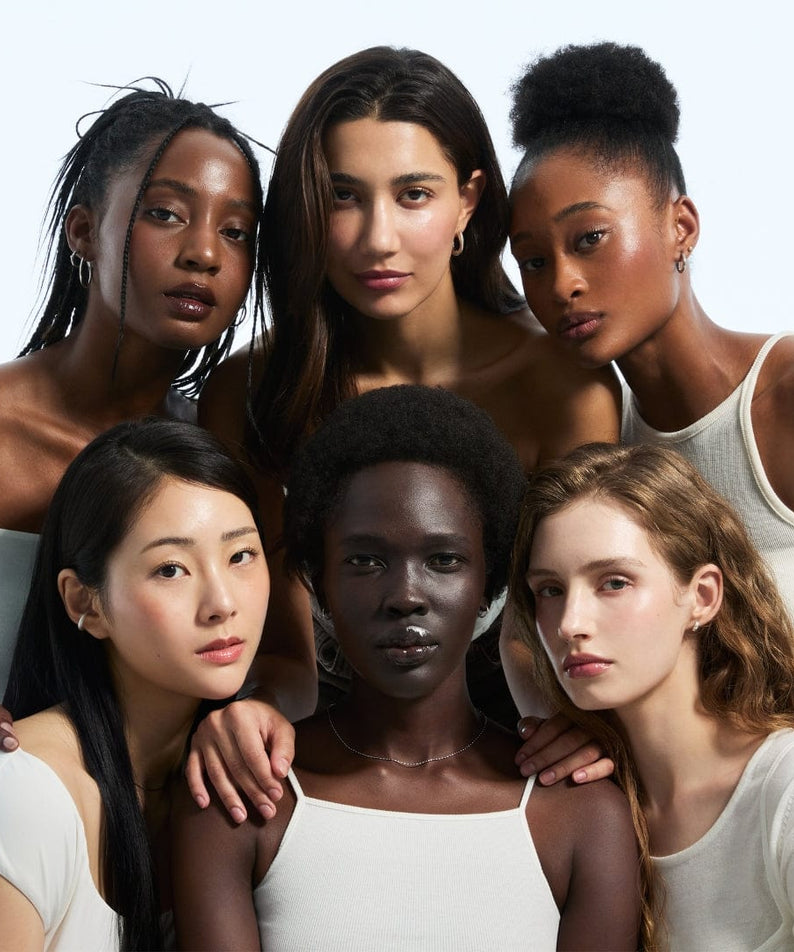 Diverse group of women posing together, showcasing beauty and diversity.