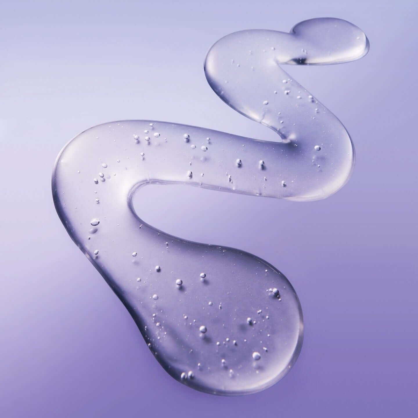 Texture of BELIF Numero 10 Essence 75ml skincare product with purple hue and droplets