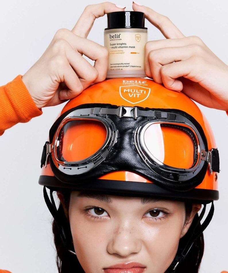 Person holding BELIF Super Knights Multi Vitamin Mask 75ml on an orange helmet.