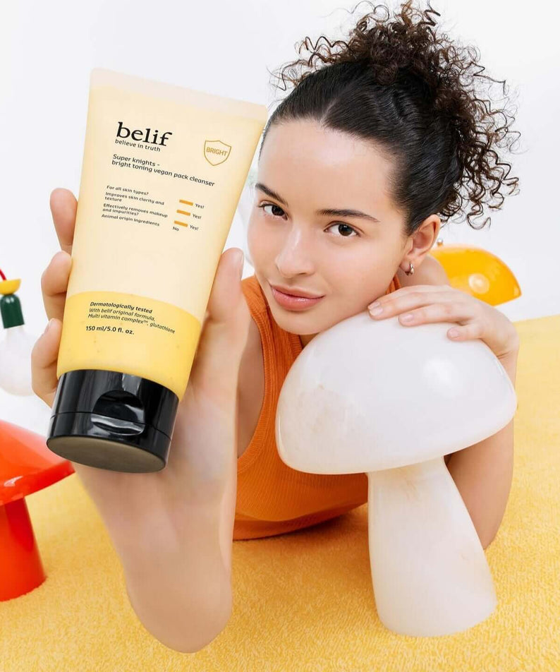 Person holding BELIF Super Knights bright Toning Vegan Pack Cleanser 150ml in a colorful setting.