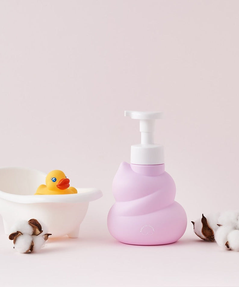 BELLBOY STUDIO Hippong Bubble Butt Cleanser bottle next to small duck tub and cotton balls on a soft pastel background
