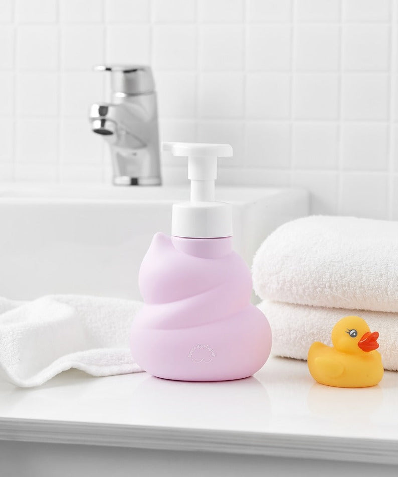 BELLBOY STUDIO Hippong Bubble Butt Cleanser in pink dispenser on bathroom counter with rubber duck and towels