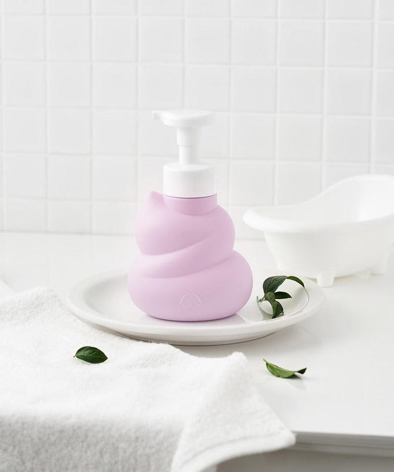 BELLBOY STUDIO Hippong Bubble Butt Cleanser in a stylish bottle on a bathroom counter next to a mini bathtub and towel