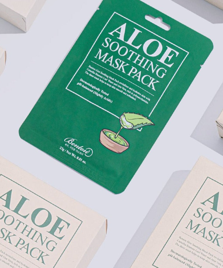 Flatlay of BENTON Aloe Soothing Mask Pack featuring green packaging with aloe leaf graphic, surrounded by multiple product boxes.