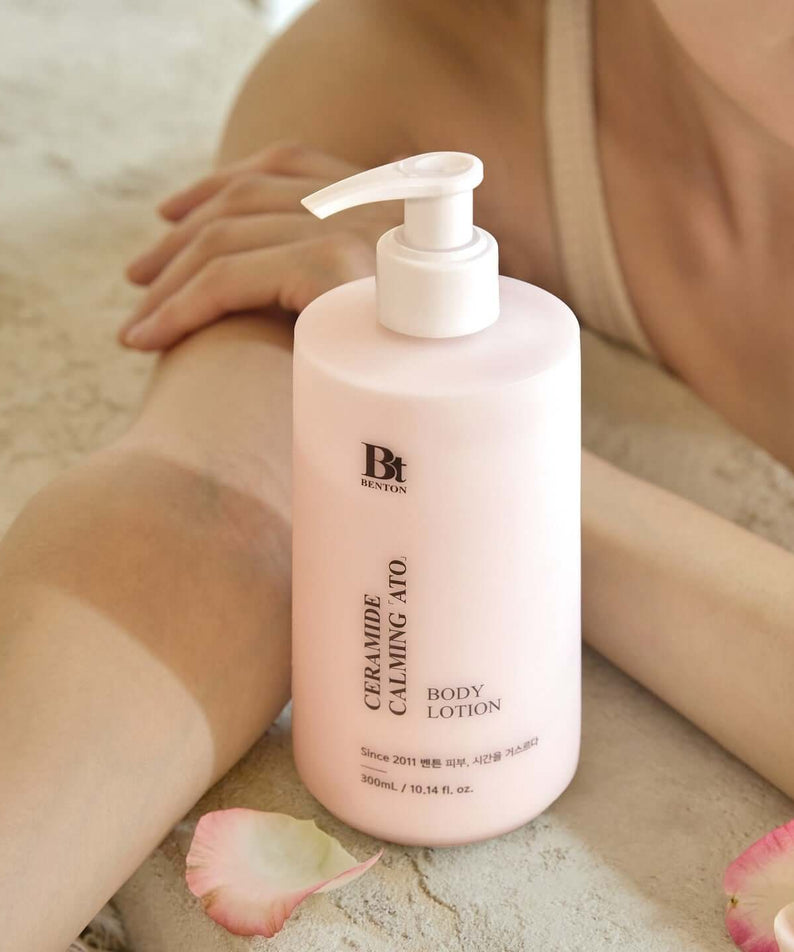 BENTON Ceramide Calming Ato Body Lotion 300ml bottle on table with person relaxing nearby
