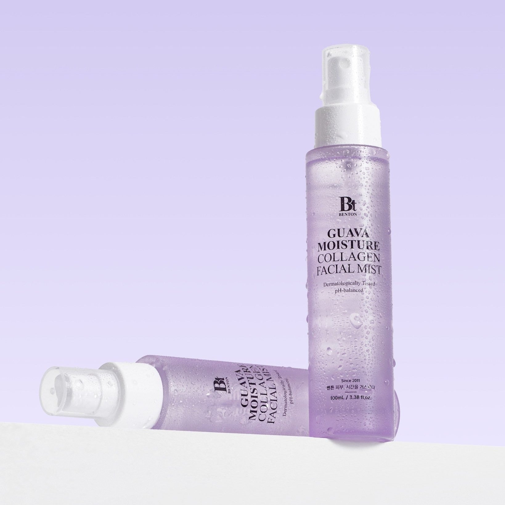 BENTON Guava Hydrating Collagen Mist 100ml skincare product with purple packaging, shown with mist droplets, for hydration and skincare benefits.