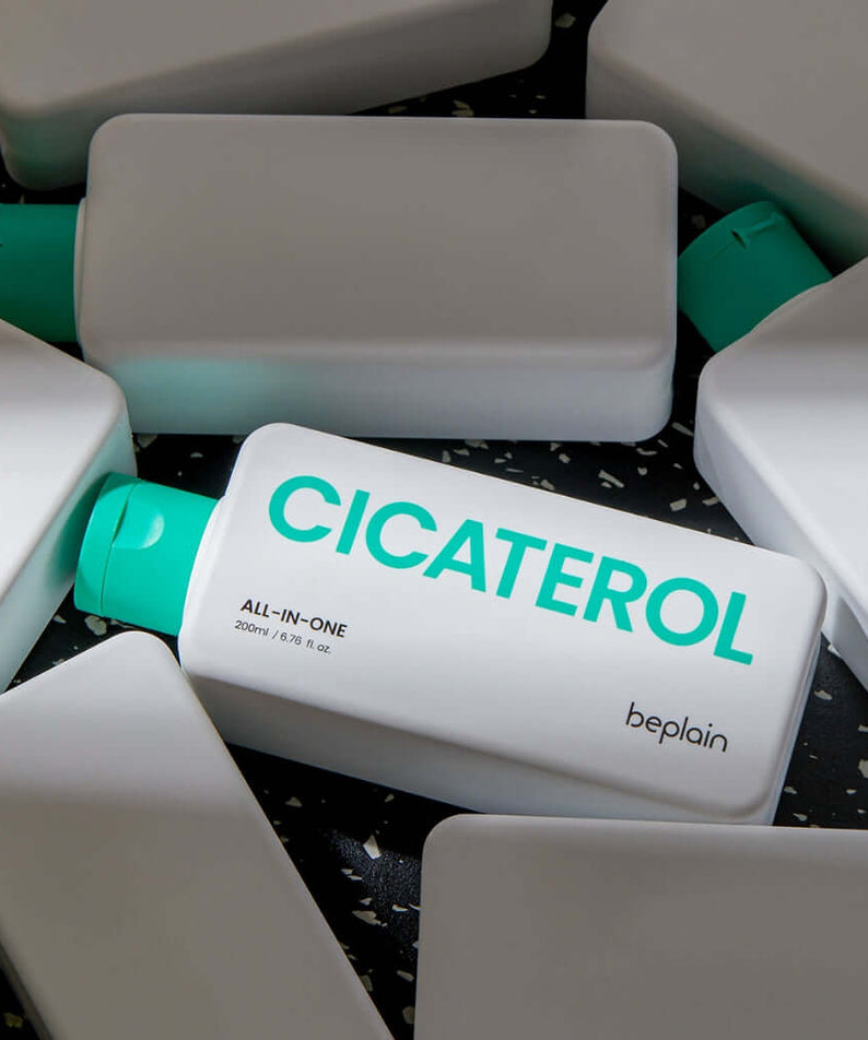 BEPLAIN Cicaterol All-in-one skincare product with green caps displayed on a dark speckled surface, highlighting the brand name.