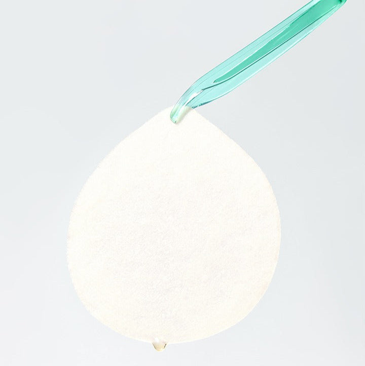 Single sheet of BEPLAIN Cicaterol Blemish Pad 80 sheets held by tweezers, designed for skin care and blemish reduction.