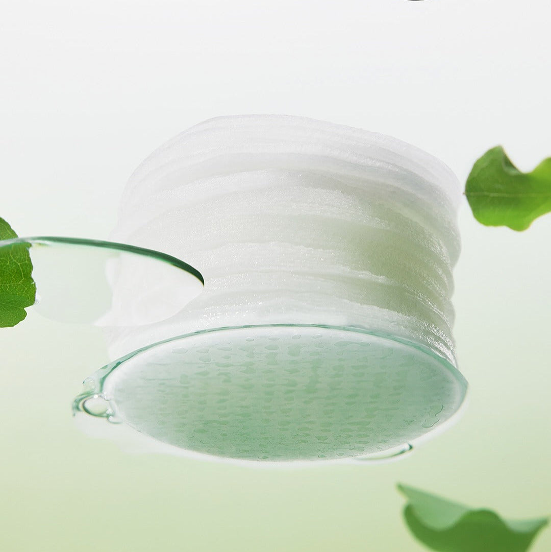 BEPLAIN Green Bean Pore Clearing Filter Pad 70 Sheets floating in water with green background