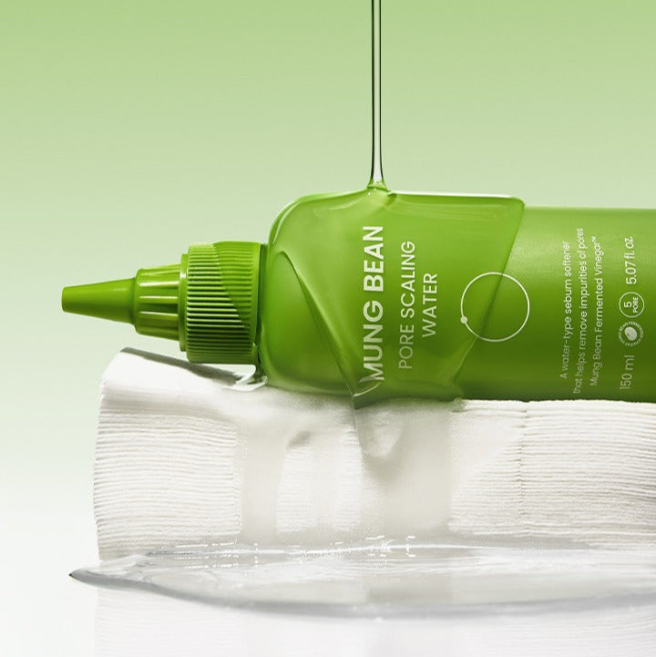 BEPLAIN Green Bean Pore Scaling Water 150ml bottle on white surface with liquid pouring against a green background.