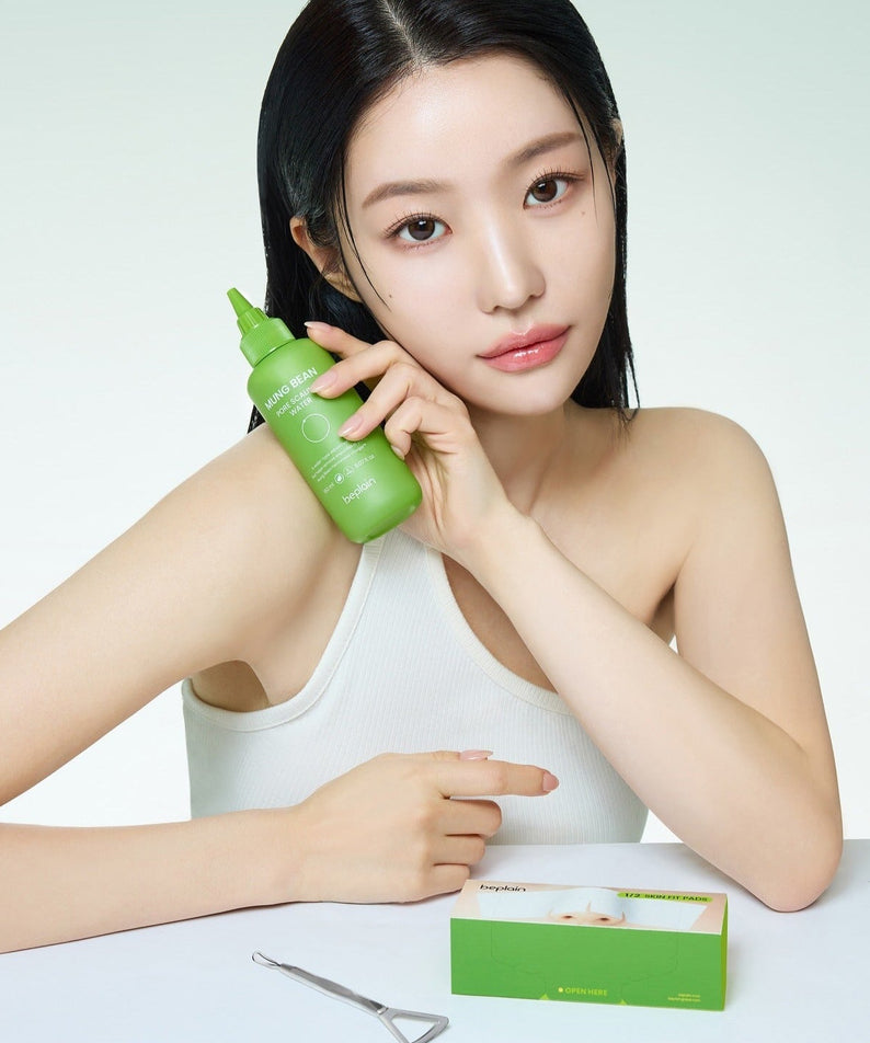 Woman holding BEPLAIN Green Bean Pore Scaling Water 150ml product next to skincare box.