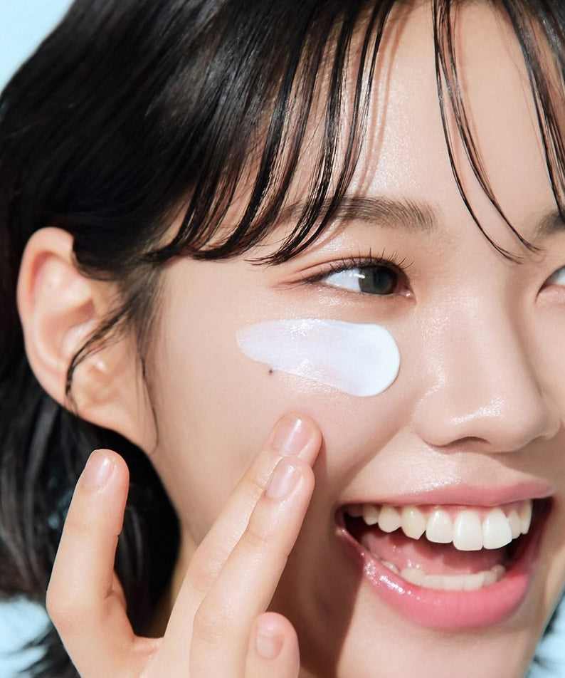 Woman applying BEPLAIN Lemon Seed Glutathione Tone-up Sun Cream 50ml for radiant skin protection
