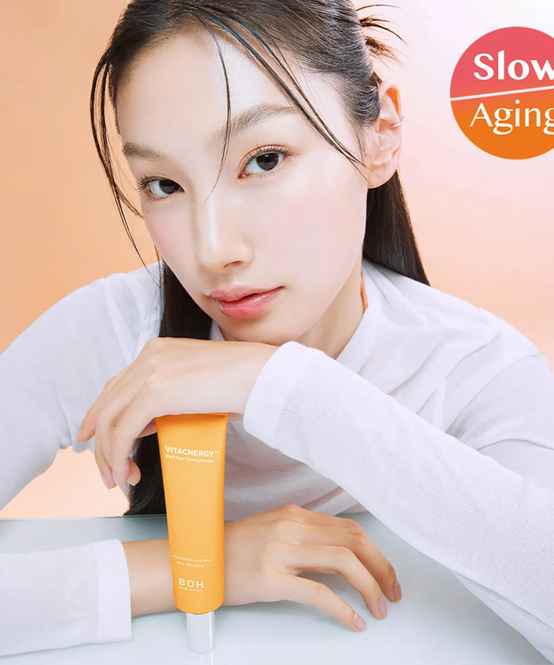 Model holding BIO HEAL BOH Vita Synergy Freckle Toning Cream 50ml for slow aging skincare benefits.