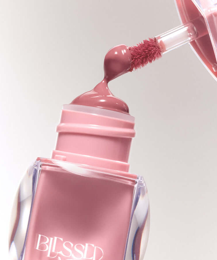 BLESSED MOON Veil Glow Lip Tint with applicator showing a rich pink color and glossy finish.