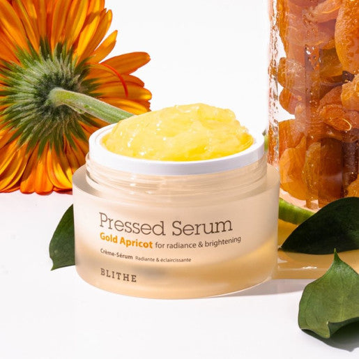 BLITHE Pressed Serum Gold Apricot 27ml/50ml in open jar with vibrant apricot texture for radiant skin