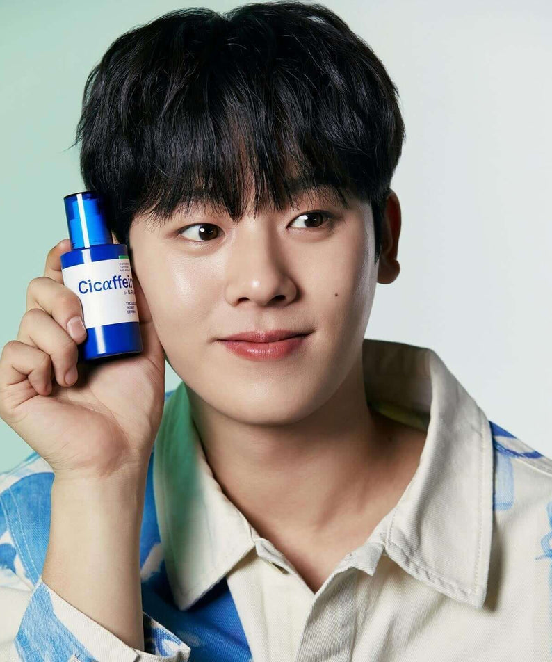 Gentleman Korea model holding B.READY Cicaffein trouble Reset Serum 40ml bottle beside face, blue packaging for men’s Korean skincare