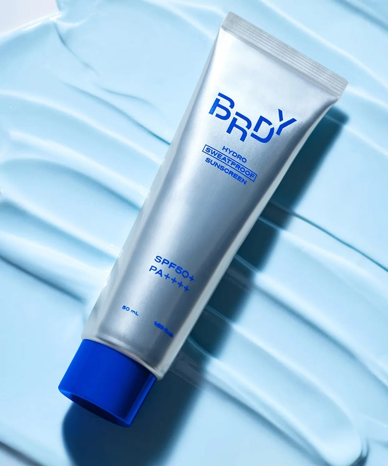 B.READY Hydro Sweatproof Sunscreen 50ml - Gentleman Korea product shot of silver tube on blue cream background, SPF50+ sweatproof sunscreen for men