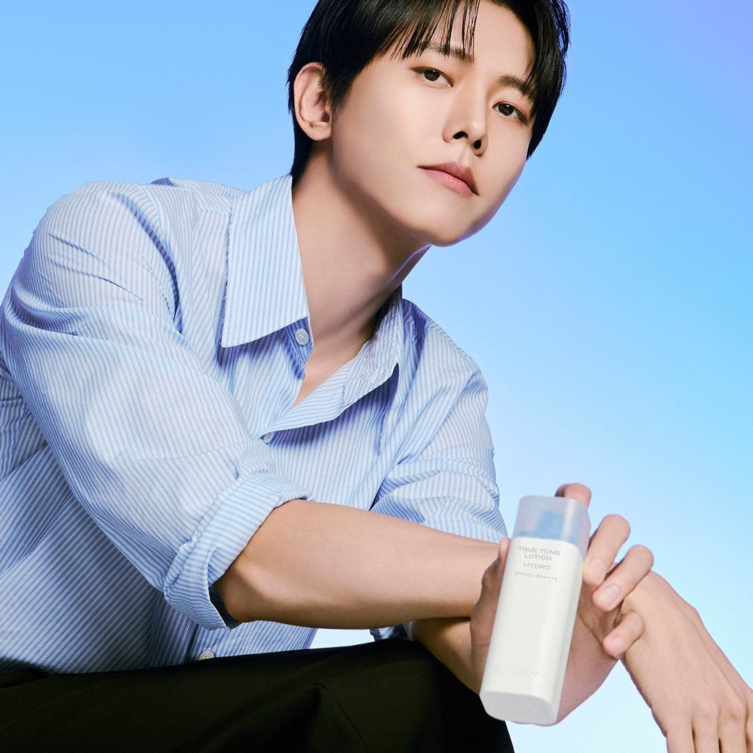 B.READY True Tone Lotion 2.0 40ml held by a well-groomed man in a blue shirt, Gentleman Korea Korean skincare for men, product-focused lifestyle shot