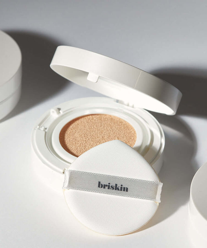 BRISKIN Exo-Glow Secondskin Cushion 15g open with applicator, highlighting its light-reflecting formula for a radiant complexion.