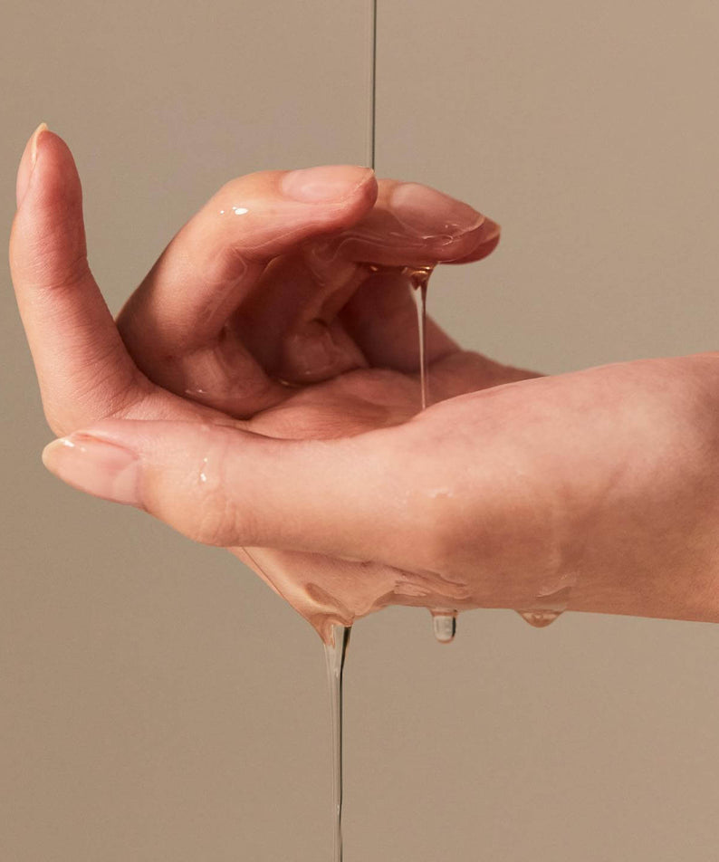 Person applying BRISKIN Exo-Oat Poreless Cleansing Oil 200ml on hands.