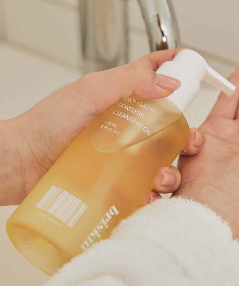 Person using BRISKIN Exo-Oat Poreless Cleansing Oil 200ml by a sink