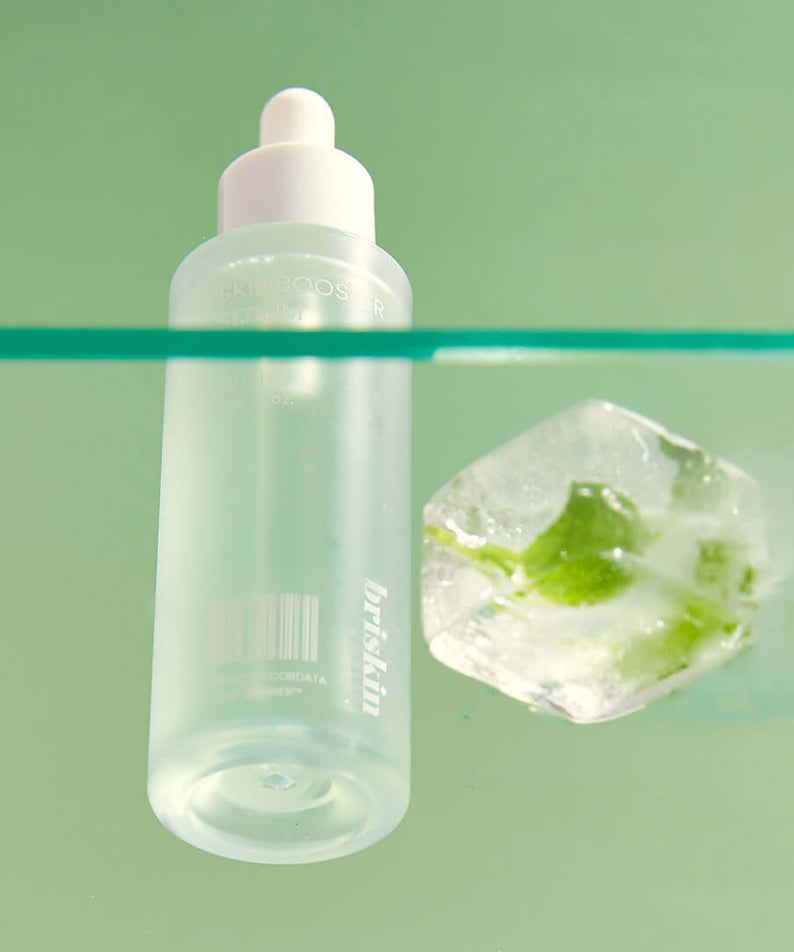 BRISKIN Houttuynia Cordata Exo-Barrier Skinbooster Serum 50ml next to green plant and ice cube on mint background