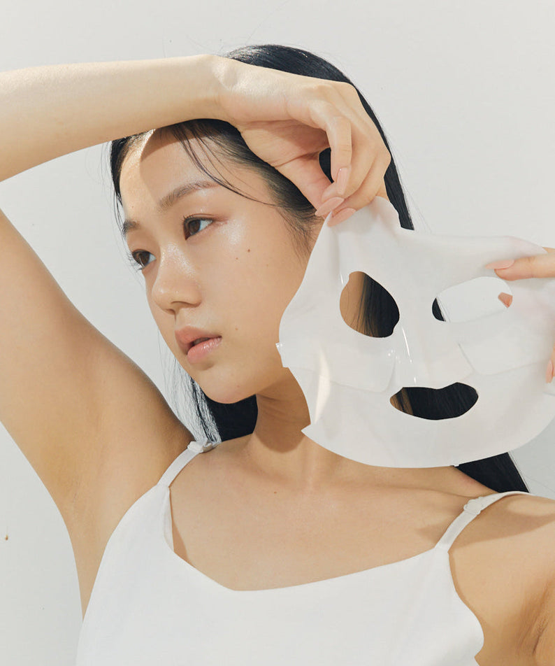 Woman applying BRISKIN Selaginella Exopeptide Collagen Mask 5 sheets on face