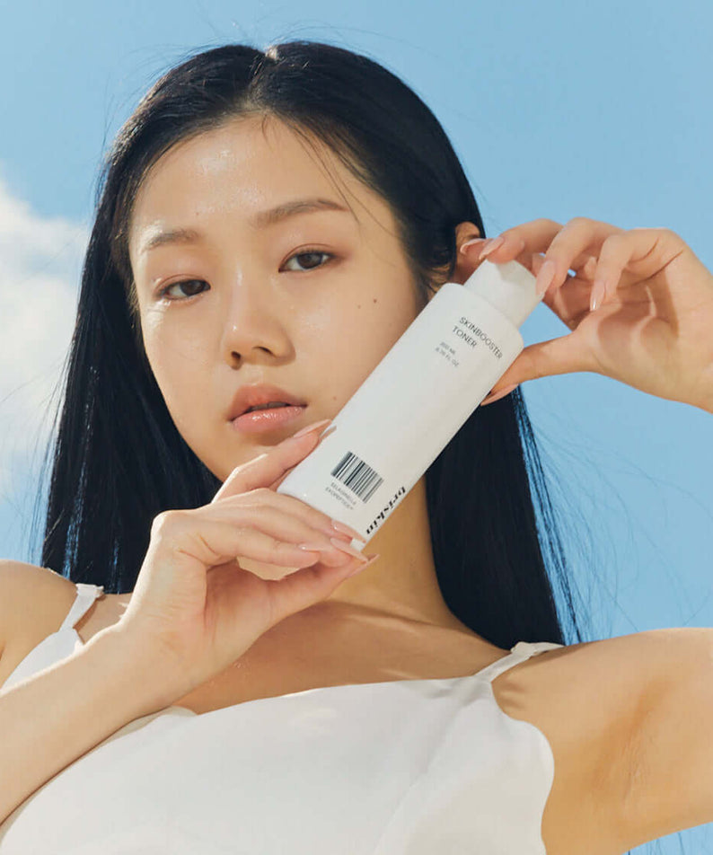 Person holding BRISKIN Selaginella Exopeptide Toner 200ml bottle outdoors