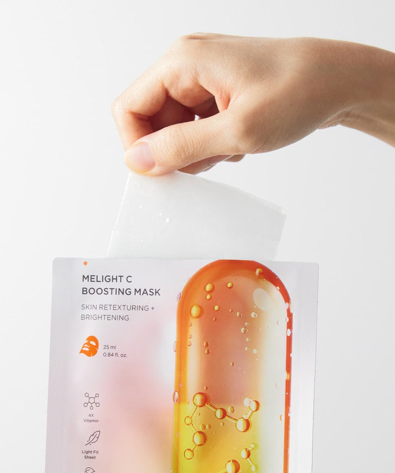 BRTC Melight C Boosting Mask 10 Sheets packaging displayed in hand for skin brightening and retexturing.