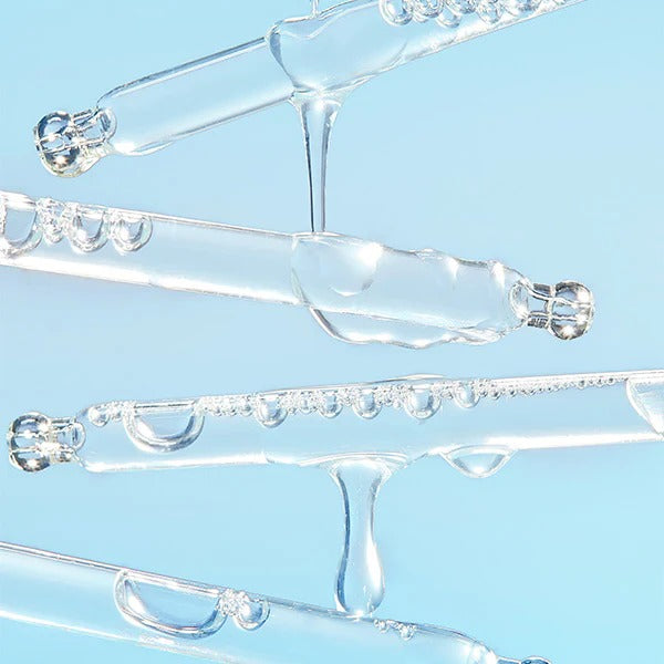 Close-up of BY WISHTREND Blue Aloe Hydrating Serum 30ml texture on dropper against light blue background