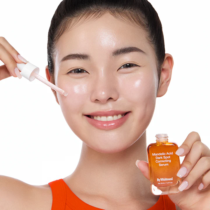 Woman applying BY WISHTREND Mandelic Acid Dark Spot Correcting Serum 30ml to her face.