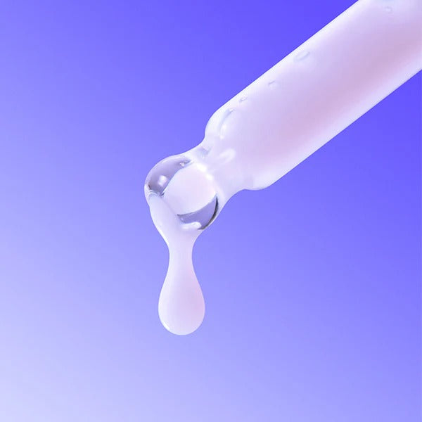 Close-up of BY WISHTREND Pore Smoothing Bakuchoil Serum 30ml dropper against a purple background.