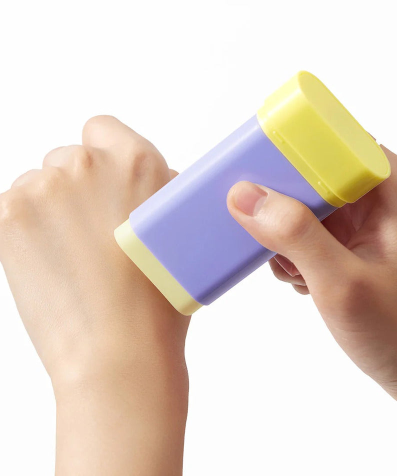 Applying BY WISHTREND Pore Smoothing Bakuchoil Sun Stick 18g on hand for sun protection and pore smoothing.
