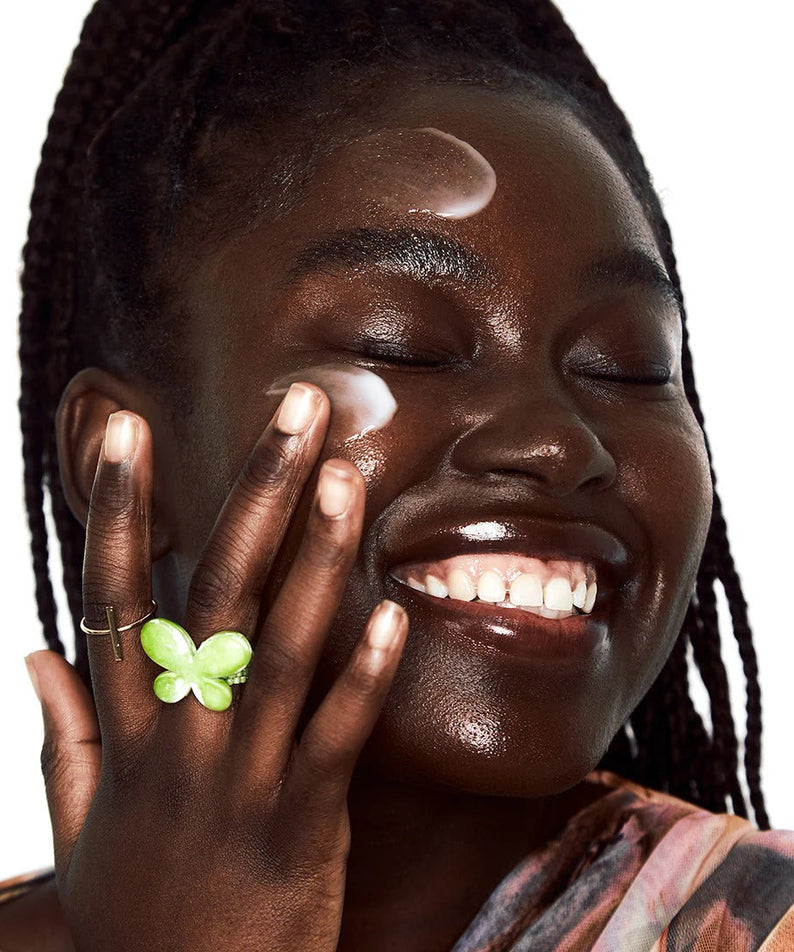 Person applying BY WISHTREND Propolis Energy Balancing Cream 50g to cheek with a smile