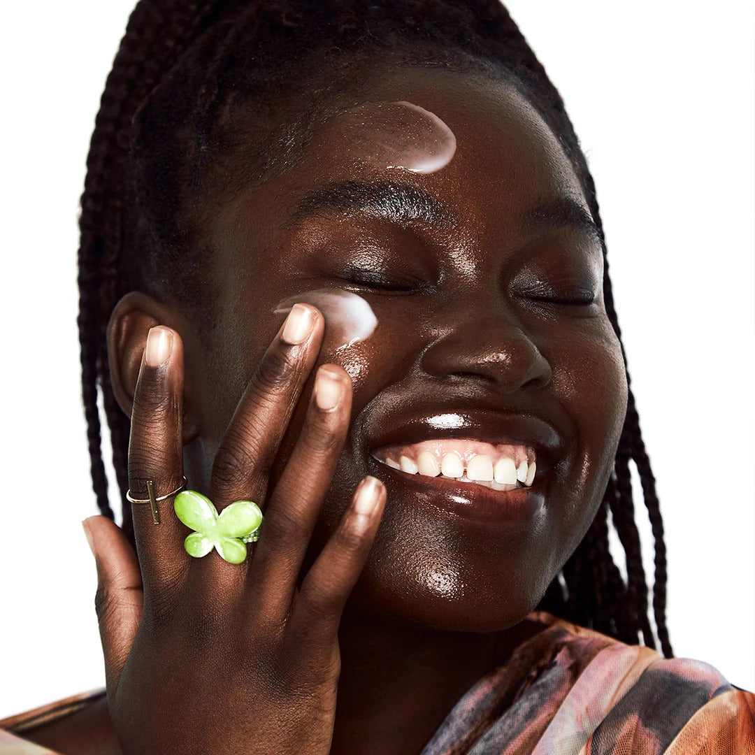 Person applying BY WISHTREND Propolis Energy Balancing Cream 50g to cheek with a smile