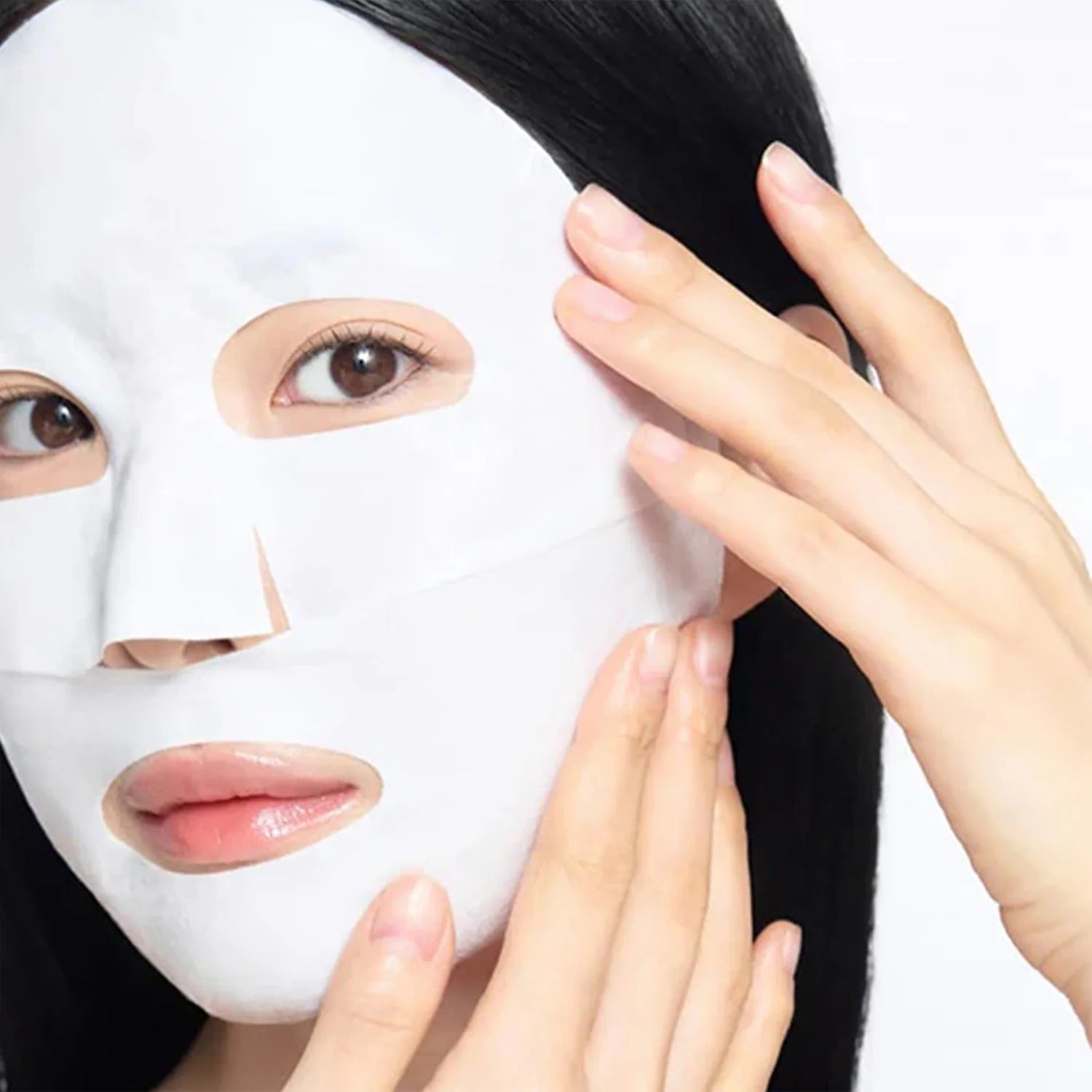 Person applying CELIMAX Brightening Pore Blemish Cream Wrapping Mask 1 Sheets for smooth and radiant skin care routine.