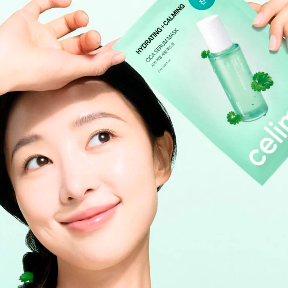 Woman holding CELIMAX Cica Serum Mask 10 Sheets with a smile, promoting hydrating and calming skincare benefits.