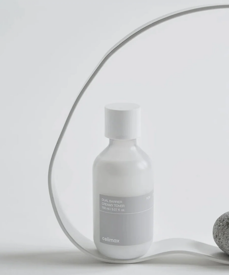CELIMAX Dual Barrier Creamy Toner 150ml bottle displayed with minimalist decor.