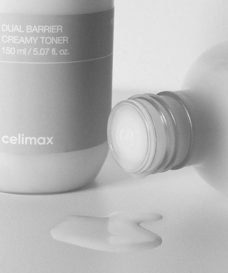 CELIMAX Dual Barrier Creamy Toner 150ml bottle with spilled toner on white surface