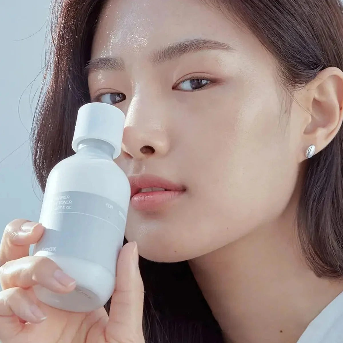 Woman holding CELIMAX Dual Barrier Creamy Toner 150ml