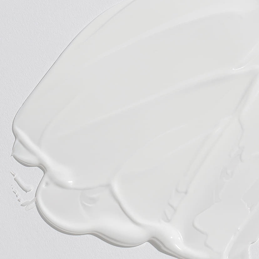 Texture of CELIMAX Dual Barrier Watery Sun Cream 40ml on a white surface, showcasing its rich, smooth consistency for skincare enthusiasts.