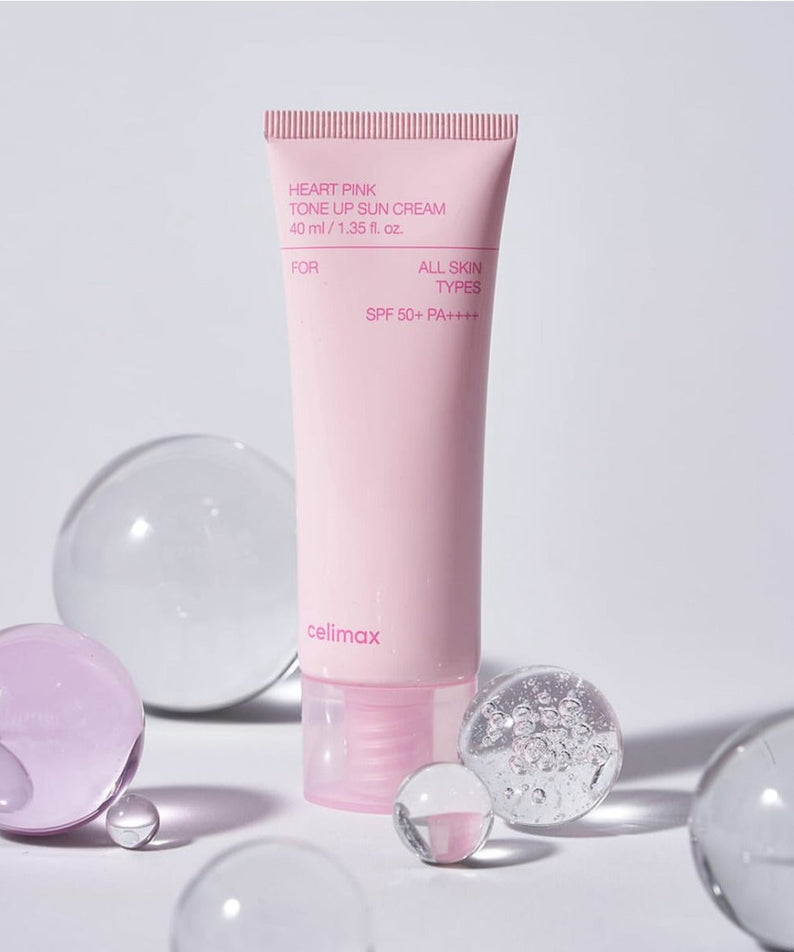 CELIMAX Heart Pink Tone-up Sun Cream 40ml with SPF 50+ surrounded by glass spheres.