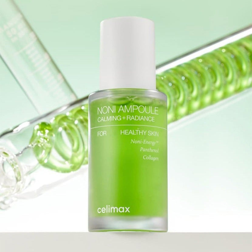 CELIMAX Noni Ampoule Calming+Radiance 30ml in green bottle for healthy skin care on reflective background