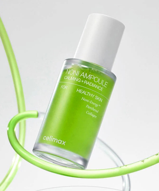 CELIMAX Noni Ampoule Calming+Radiance 30ml in green bottle, skincare product for soothing and glowing skin.