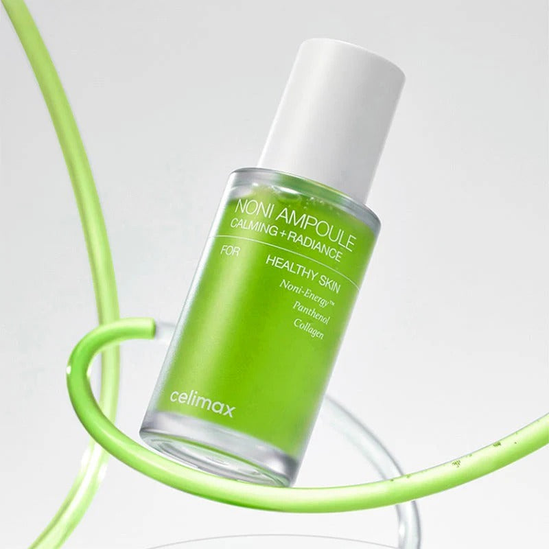CELIMAX Noni Ampoule Calming+Radiance 30ml in green bottle, skincare product for soothing and glowing skin.