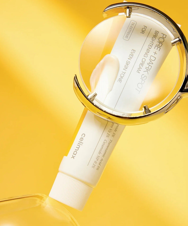 CELIMAX Pore Dark Spot Brightening Cream 35ml under magnifying glass on yellow background