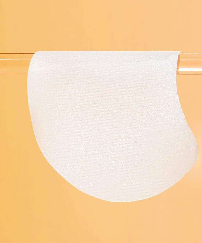 CELIMAX Pore Dark Spot Brightening Pad 40ea displayed on a clear rod against an orange background